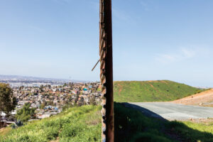 A wall divides two landscapes.