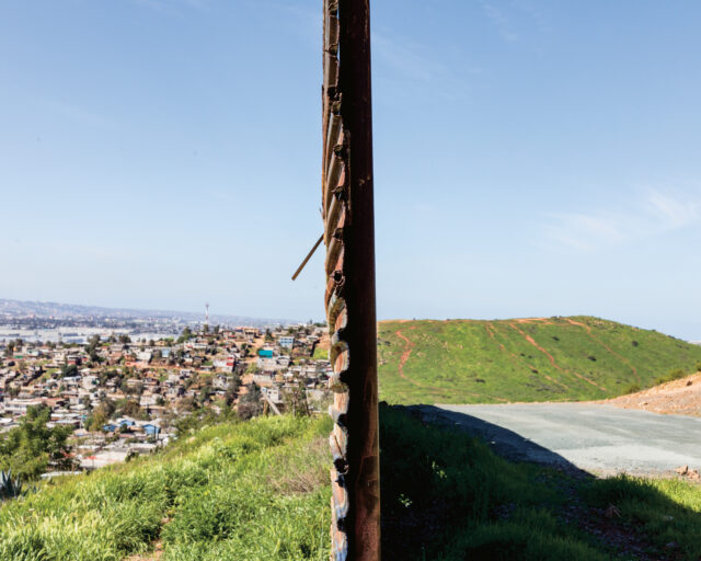 A wall divides two landscapes.